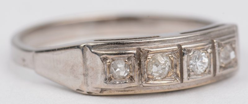 Een 14 K witgouden ring bezet met vier diamanten met een gezamenlijk gewicht van +- 0,12 ct.
