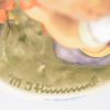 “The floris”. Een beeldje van meerkleurig biscuit uit de reeks van M. I. Hummel. Gemerkt ondereaan. No. 349/0.