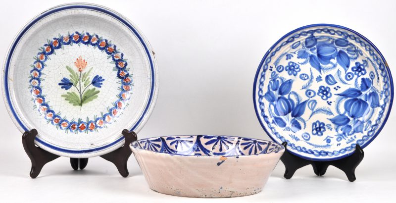 Drie verschillende schotels van blauw en wit en meerkleurig aardewerk. XIXe eeuw.