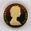 1 gouden munt van 100 CAD. St. John’s Newfoundland. Au 917/1000. Canada, 1983. Recto: Queen Elizabeth II, verso: anker, schip en gebouw. In etui en certificaat van Royal Canadian Mint.