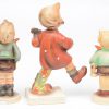 “Wanderlied”; “Dorfbub” & “Junge mit Holzpferd”. Drie beeldjes van meerkleurig biscuit uit de reeks van M.I. Hummel. Onderaan gemerkt. Kleine beschadigingen.