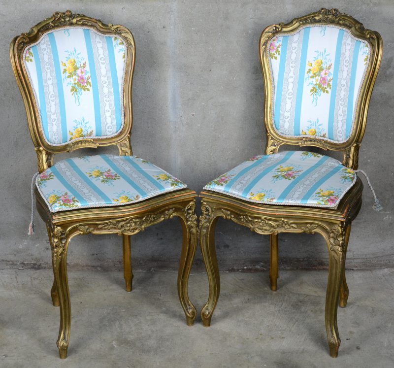 Een paar stoeltjes van goudgepatineerd hout in Lodewijk XV-stijl.