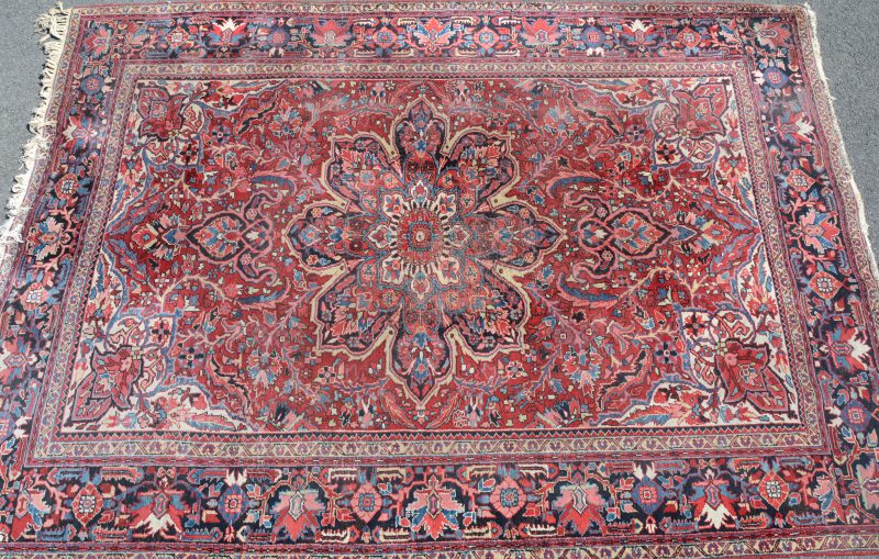 Een handgeknoopt Perzisch wollen tapijt. Slijtage in het medaillon.