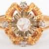 Een 18 K wit en geelgouden ring bezet met diamanten oude slijp met een gezamenlijk gewicht van +- 0,20 ct.