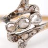 Een 18 K wit en geelgouden ring bezet met diamanten oude slijp met een gezamenlijk gewicht van +- 0,25 ct.