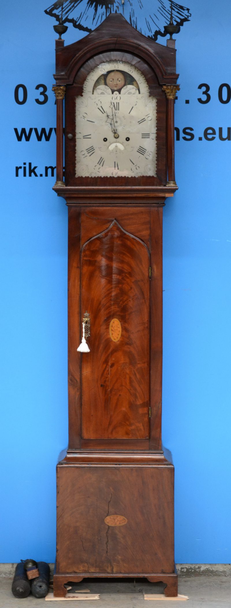 Een gefineerde mahoniehouten staande klok. Het deurtje versierd met ingelegde schelp. XIXe eeuw.