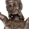 Een art deco danseres van brons op meersoortig marmeren sokkel, naar een werk van Chiparus.
