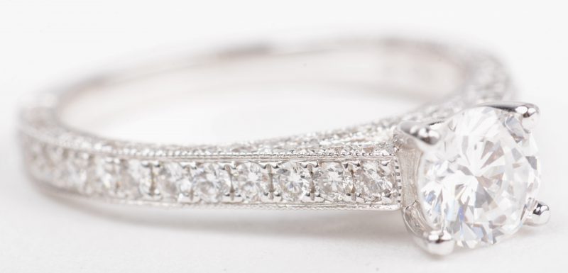Een 18 K witgouden ring bezet met een briljanten met een gezamenlijk gewicht van +- 0,49 ct. en een centrale briljant van +- 0,70 ct.