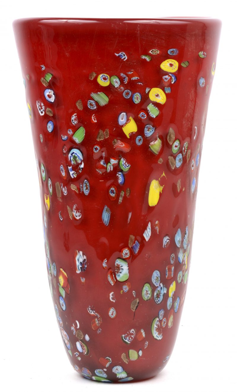Een vaas van rood Muranoglas met een meerkleurig milefioridecor.