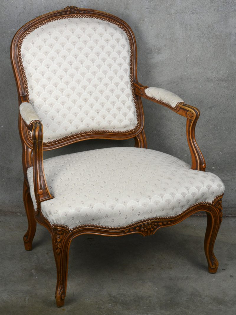 Gebeeldhouwde notenhouten fauteuil à la Reine in Lodewijk XV-stijl. Bekleed met zijde.