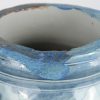 Een grote aardewerken vaas met blauw op wit decor en met vogelkoppen als handvatten. Randschade en gat in de bodem door eerdere montage als lampvoet.