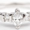 Een 18 K witgouden ring bezet met een diamant markies slijp en diamant baguettes met een gezamenlijk gewicht van +- 0,35 ct.
