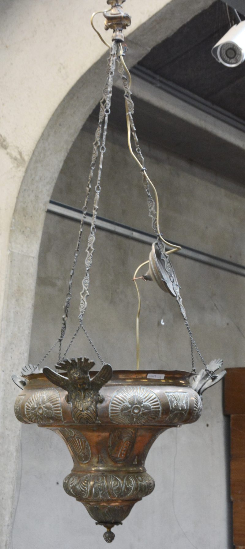 Een messingen godslamp versierd met engeltjes.
