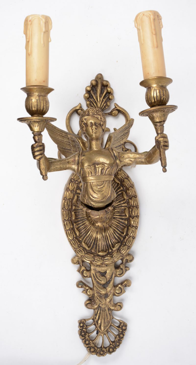 Een verguld bronzen applique met twee lichtpunten, gedragen door een engel.