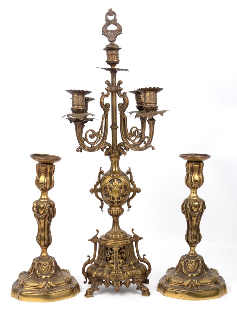 Een paar verguld bronzen kandelaars in barokke stijl en een eclectische kandelaar met vier armen.