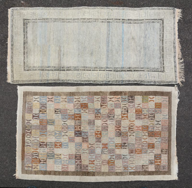 Twee handgeknoopte wollen karpetjes, waarbij één Tibetaans.