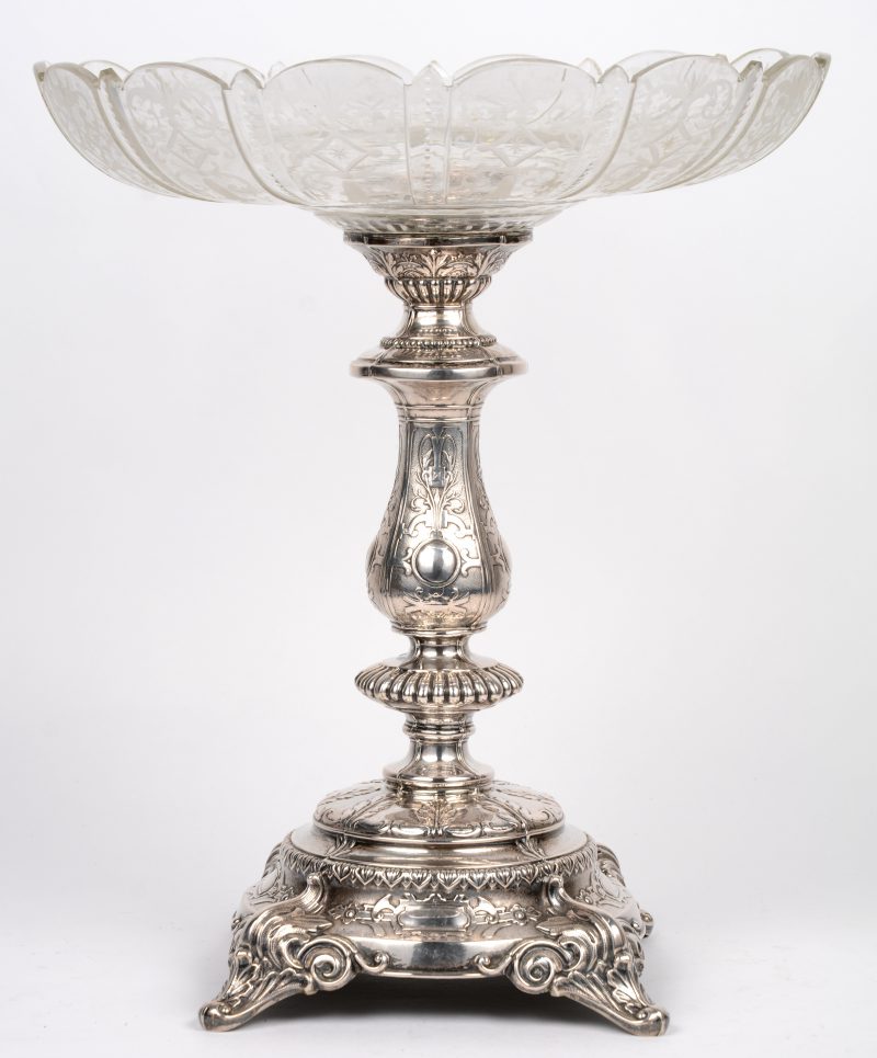 Een milieu de table met geslepen kleurloos kristallen coupe op 800 ‰ zilveren voet in barokke stijl. 988,90 gram.