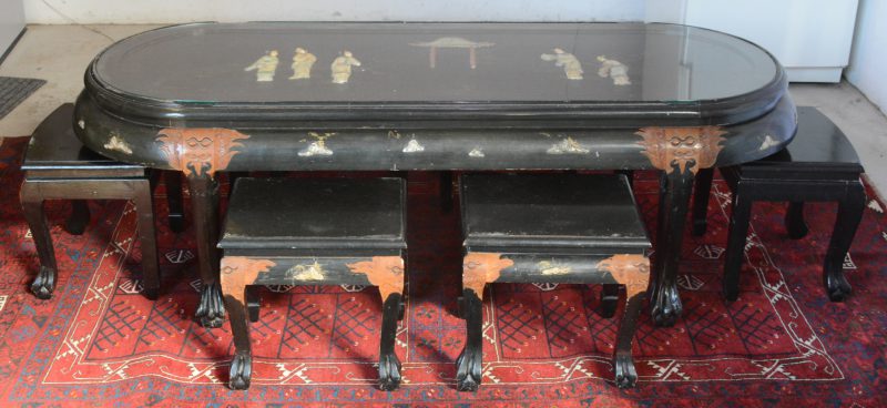 Lage Chinese tafel van zwartgelakt hout met ingelegde decors van pietra dura met glazen blad en zes bijpassende stoelen.