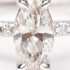 Een 18 K witgouden ring bezet met een diamant markies van +- 0,60 ct. en briljanten met een gezamenlijk gewicht van +- 0,20 ct.