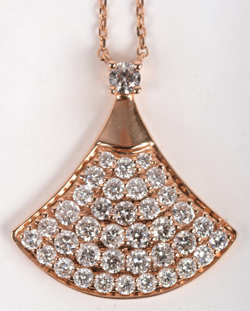 Een 18 K roze gouden ketting met hanger bezet met briljanten met een gezamenlijk gewicht van +- 1,06 ct.