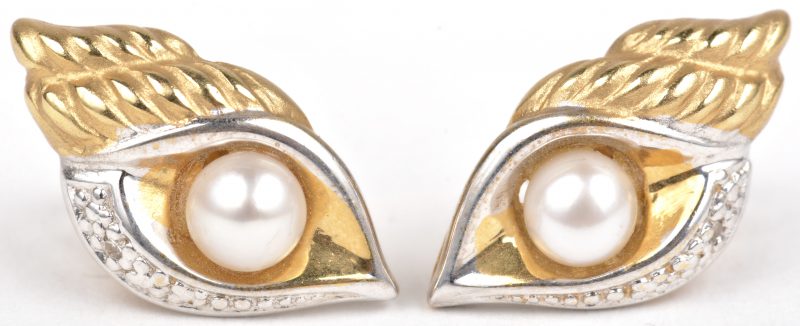 Een paar 18 K wit en geelgouden oorbellen bezet met telkens één parel.