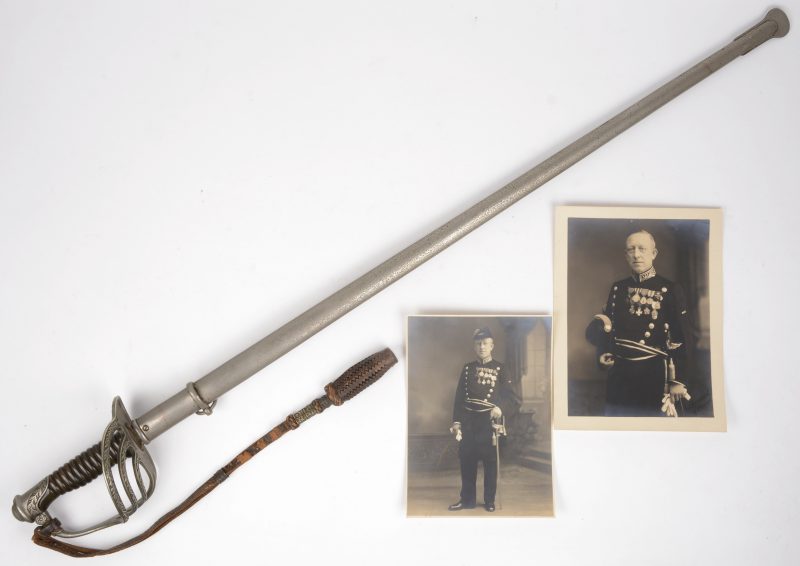Een Belgisch officierssabel. Eind XIXe eeuw. Bijgevoegd twee foto’s van de officier, eigenaar van het sabel.