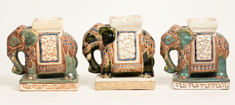 Drie geglazuurd Chinees aardewerken olifantjes met asbakken.