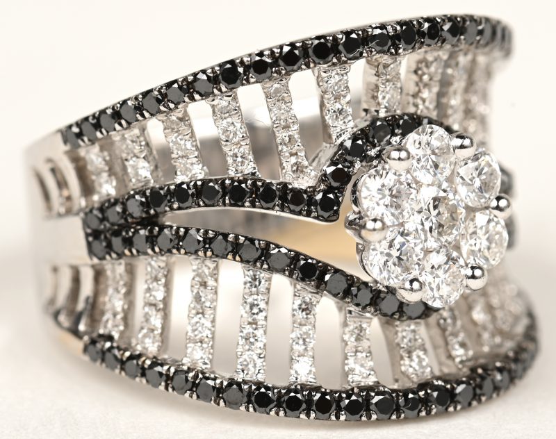 Een 18 K witgouden ring bezet met briljanten en zwarte diamanten met een gezamenlijk gewicht van +- 1,52 ct.