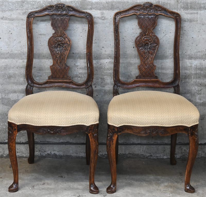 Een paar houten stoelen met fijn uitgestoken ruggen. Tijdperk Régence; omstreeks 1730-1740.