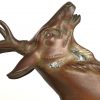 “Hertenbok en jachthond”. Een art deco groep van gepatineerd brons op sokkel van onyx .
