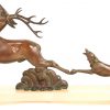 “Hertenbok en jachthond”. Een art deco groep van gepatineerd brons op sokkel van onyx .