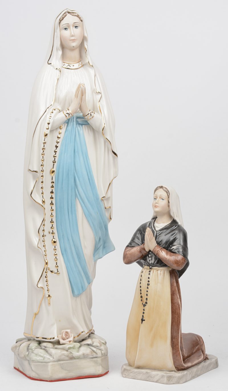 “Onze Lieve Vrouw van Lourdes en Bernadette”. Twee beeldjes van veelkleurig porselein en biscuit. Italiaans werk.