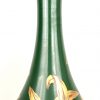 Een grote art nouveau vaas van aardewerk versierd met vergulde narcissen op groen glazuur in de geest van St-Radegonde aardewerk. Onleesbaar gemerkt.