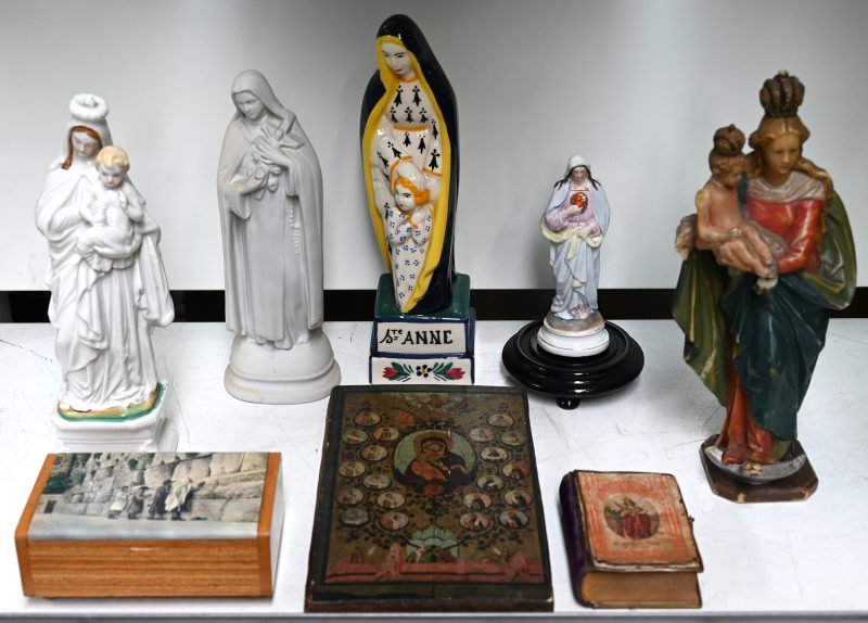 Een lot religiosa, bestaande uit vijf Madonnabeeldjes (biscuit, Brussels porselein, aardewerk van Quimper en was), een doosje met afbeelding van de klaagmuur, een reproductie van een icoon en een missaaltje.