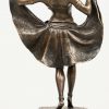 Een bronzen art deco danseresje met openklappende rok. Op marmeren sokkel.
