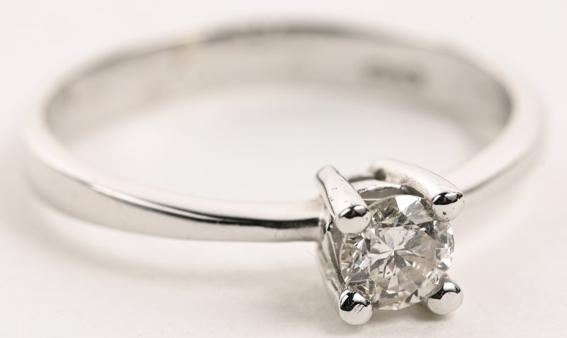 Een 18 K witgouden ring bezet met één briljant van +- 0,32 ct.