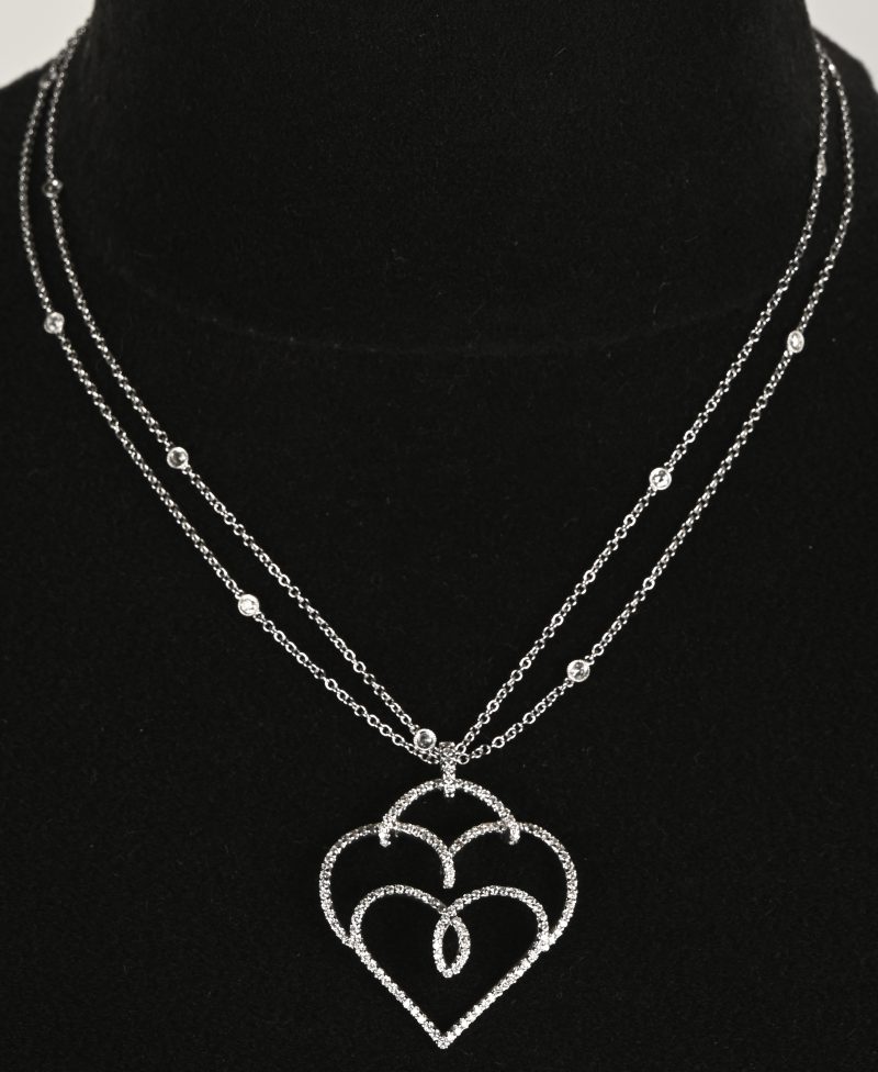 Een 18 K witgouden ketting met 18 K witgouden hanger in de vorm van een hart bezet met briljanten met een gezamenlijk gewicht van +- 2,24 ct.