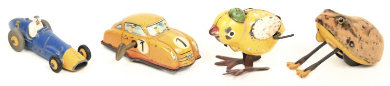 Een lot blikken speelgoed bestaande uit een racewagen, een kuiken en een pluizige kikker. We voegen er een Dinky Toy Ferrari aan toe.