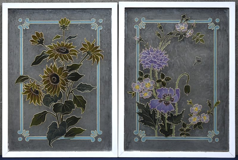 Een set van twee art nouveau glasramen gedecoreerd in relief met bloemen. Gedateerd 1906 (bijgevoegde documentatie).