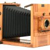 Een oude houten fotocamera met balg. Met platen, enkele lenzen en toebehoren. Begin XXste eeuw.