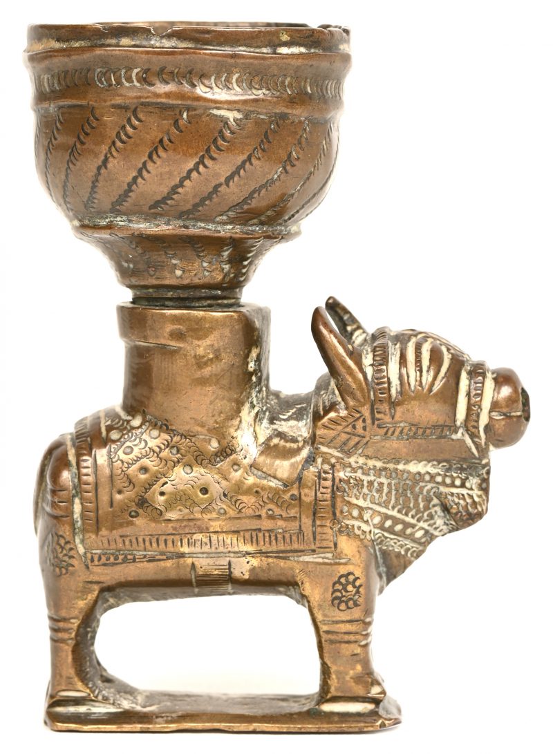 Een bronzen olielampje gemonteerd op een versierd rund. Indisch werk, XIXde eeuw.