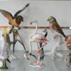 Een collectie van 11 diverse vogels van polychroom Duits porselein, gemerkt Rosenthal, Hutchenreuter (o.m. Granget), Herend e.a.