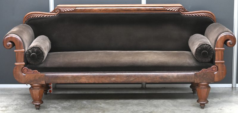 Een Biedermeier sofa met 2 rolkussen onder de armleuning, 19e eeuws met walnoot houten gesculptuurd frame en geherstoffeerd, chocolade bruin velour bekleding.Koperen wieltjes apart te bevestigen, waarvan 1 gebroken te herstellen.