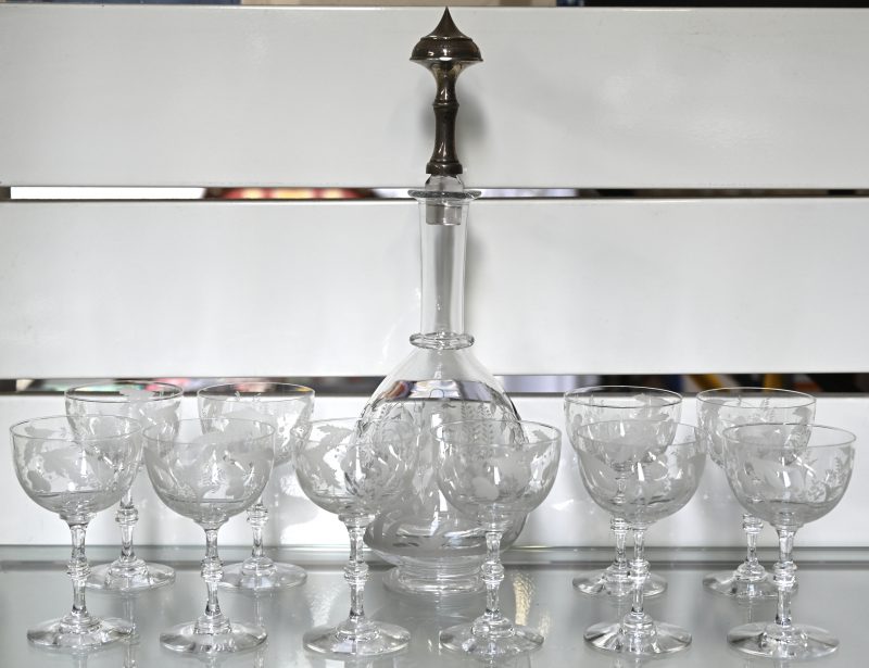 Een set van een kristallen karaf met tien glazen, handgeslepen met een floraal decor.