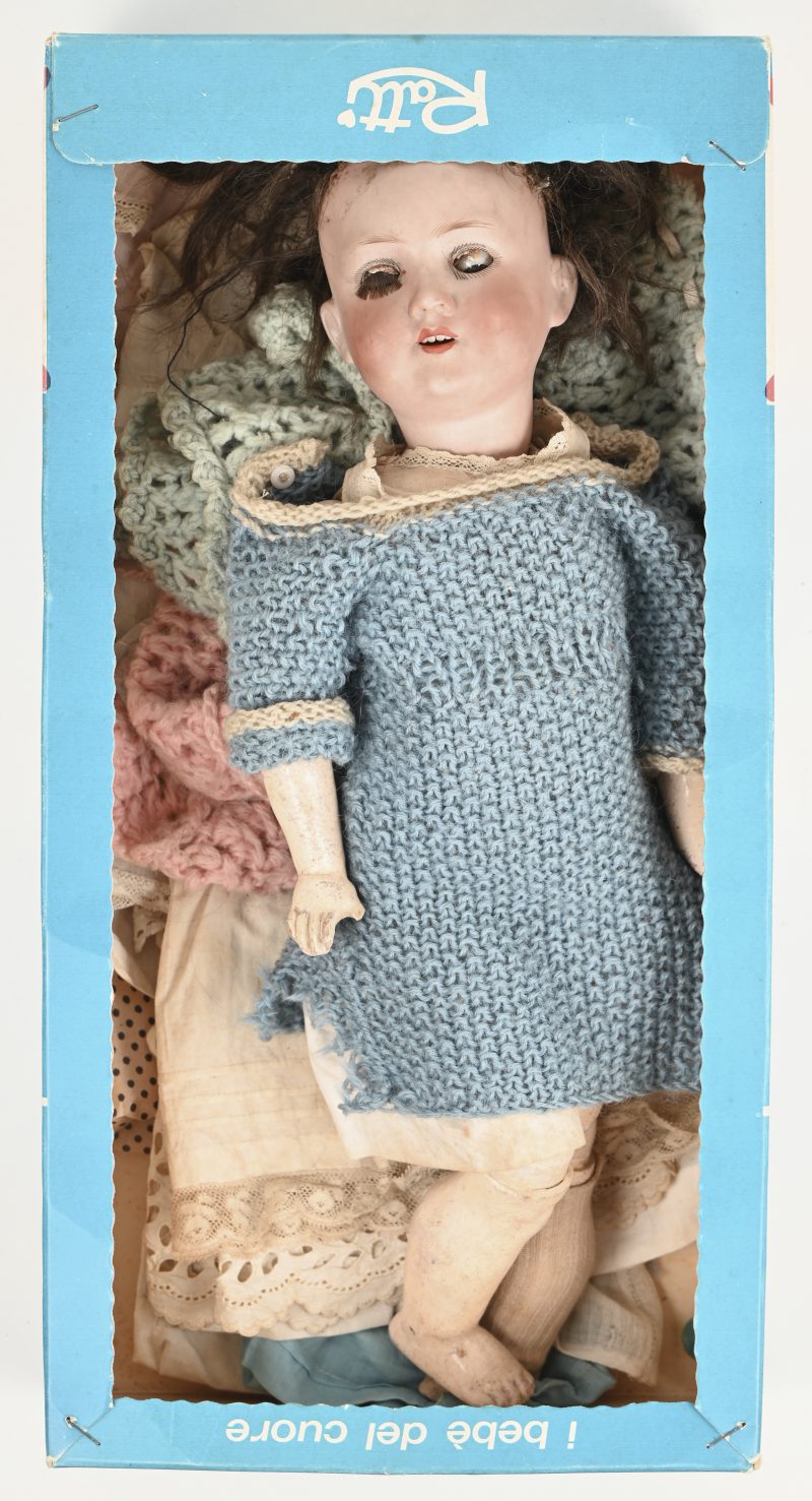 Een vintage porseleinen pop met aantal kledingstukken. Gemerkt “Armand Marseille Germany”, genummerd 390 A 2 1/2 M. Schilferschade aan vinger en voet topjes. Niet in originele doos.