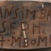 “Joseph Bansimba”.  Een uit wengé hout gesculptuurde buste van een Afrikaanse man, inscriptie onderaan “Bansimba. Joseph. 47. Mbomu.”