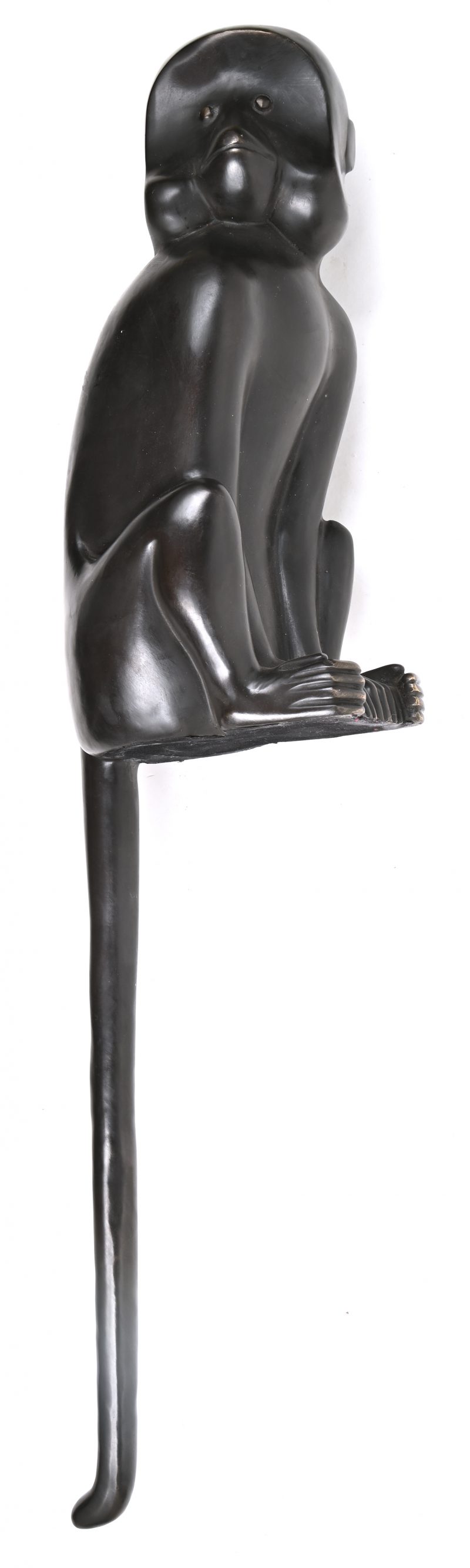 Een bronzen beeld van een aap , gemaakt om op de rand van de tafel of kast te zetten met de staart neerwaarts gericht.