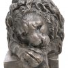 Een brons gesculptuurd beeld van een leeuw in lighouding.