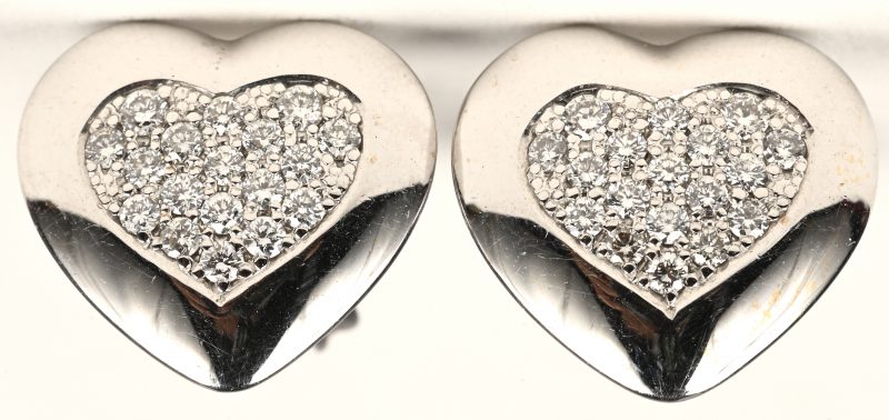 Een paar 18 karaats witgouden hartvormige oorbellen bezet met briljanten met een gezamenlijk gewicht van +- 0,42 ct.