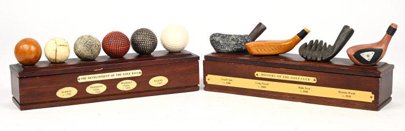 “History of the golf club” & “The development of the golf ball”. Een paar houten bureau deco pennendoosjes met golf gerelateerde ornamenten.